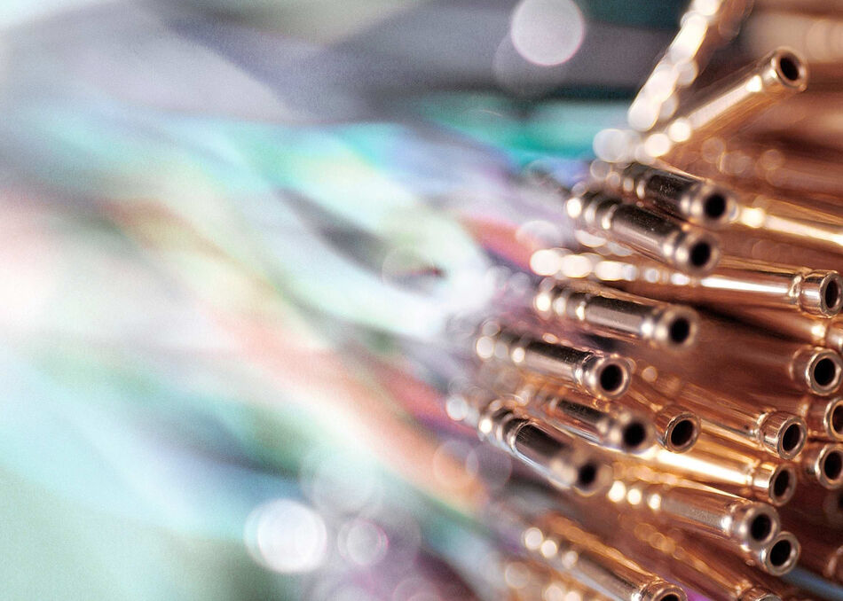 Miniaturized coaxial wires with crimp connectors, emphasizing the visible crimp indicator mark, wire test hole, and insulation support for quality control inspection.